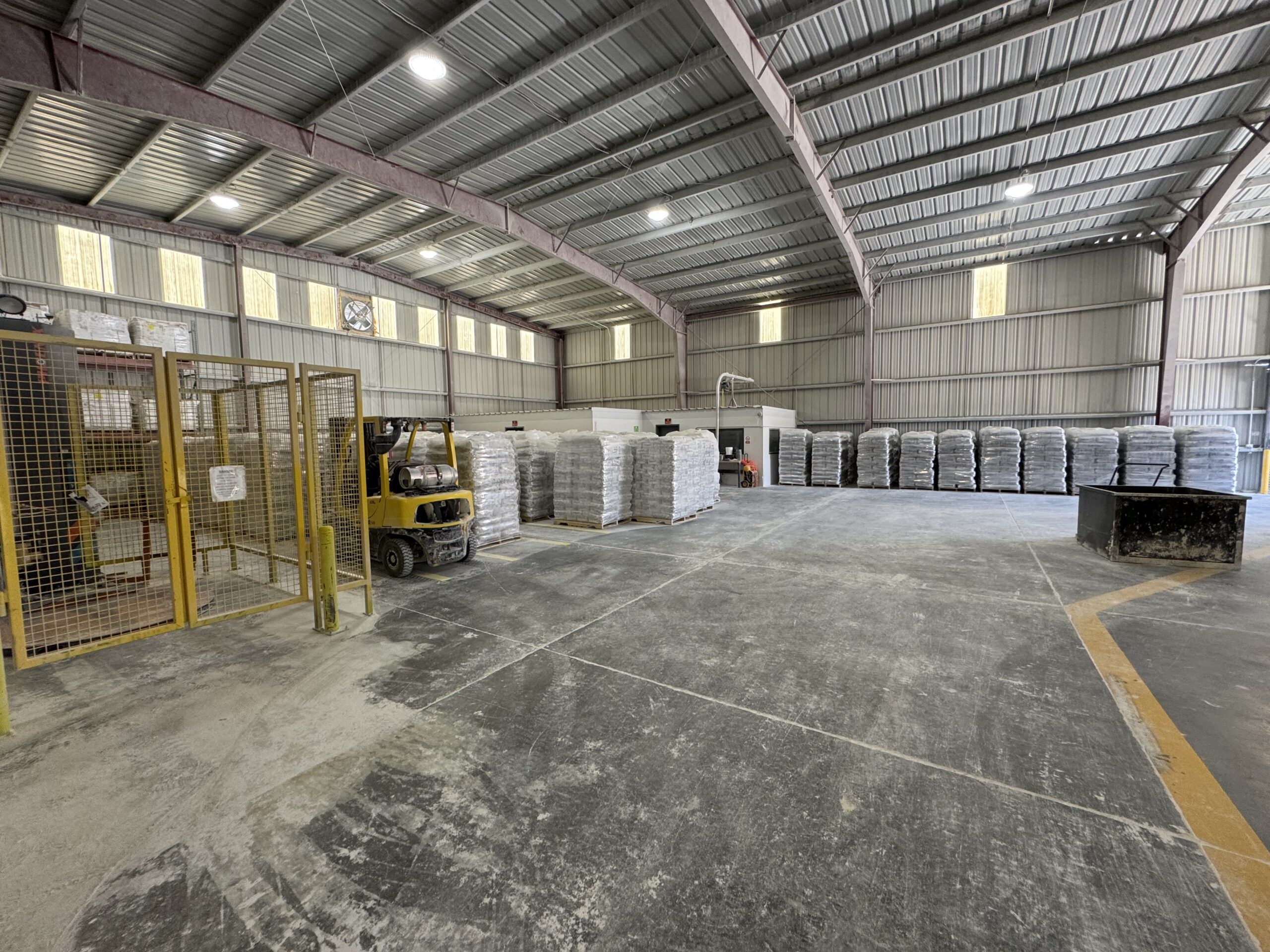 Forklift and stacked product pallets inside Pure Mountain’s warehouse.